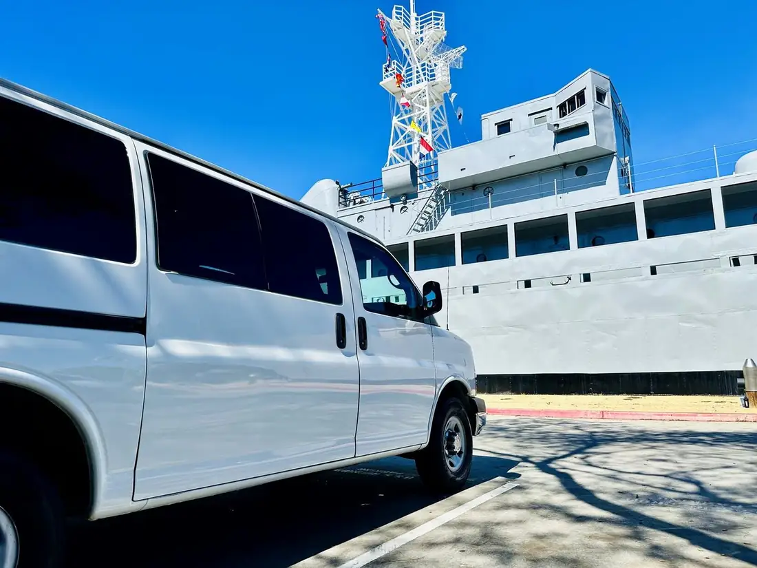 Flota-managed 10-passenger Chevrolet Express van parked at the harbor near San Diego International